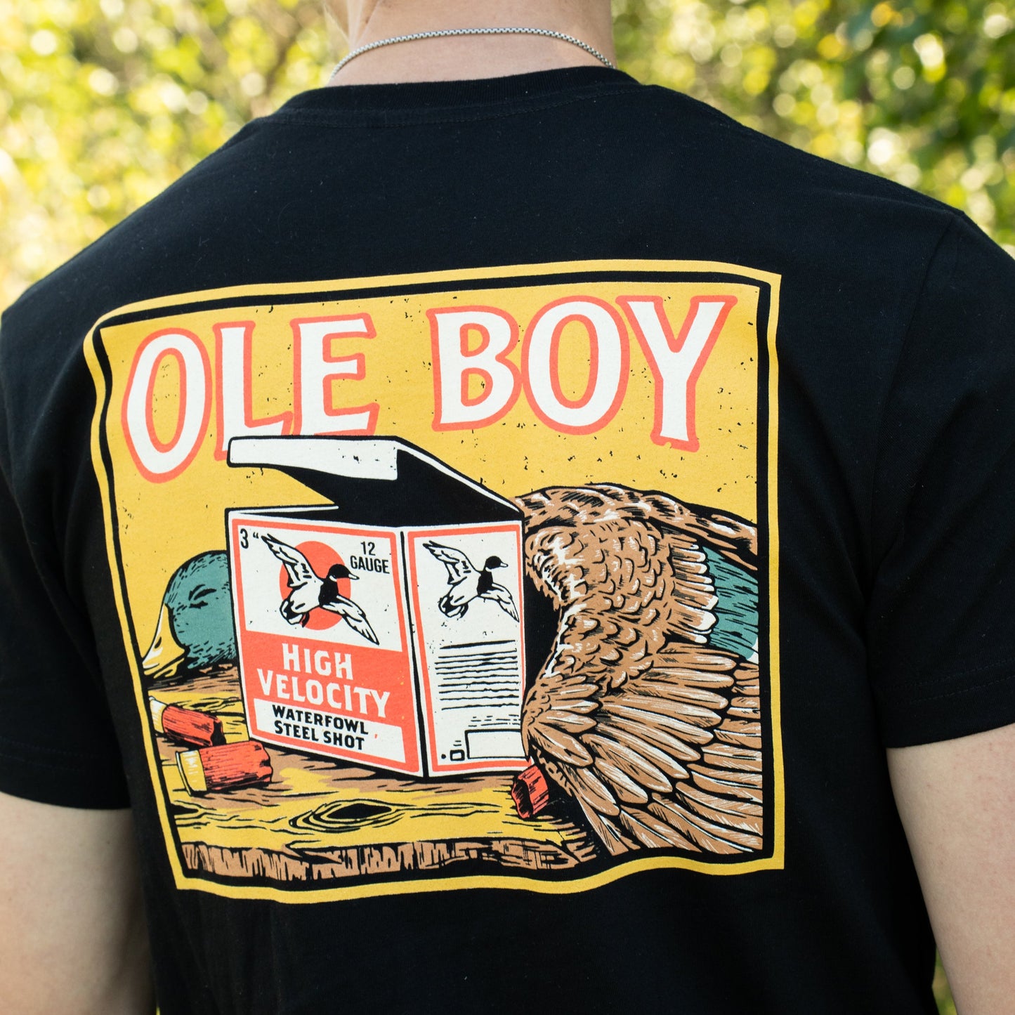Black t-shirt with 'OLE BOY' graphic design featuring a duck and high velocity ammunition box.