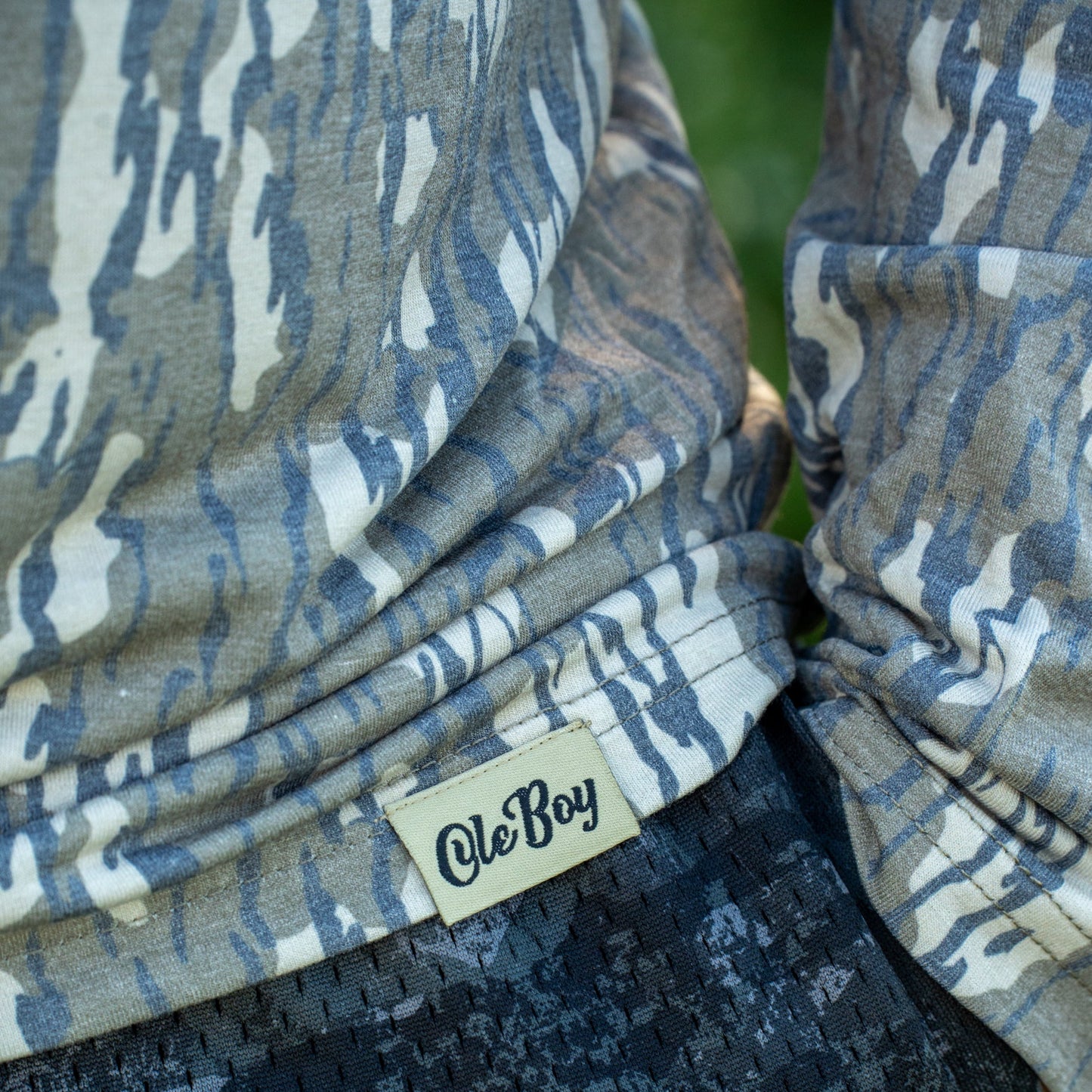Camouflage-patterned fabric with 'Ole Boy' brand label