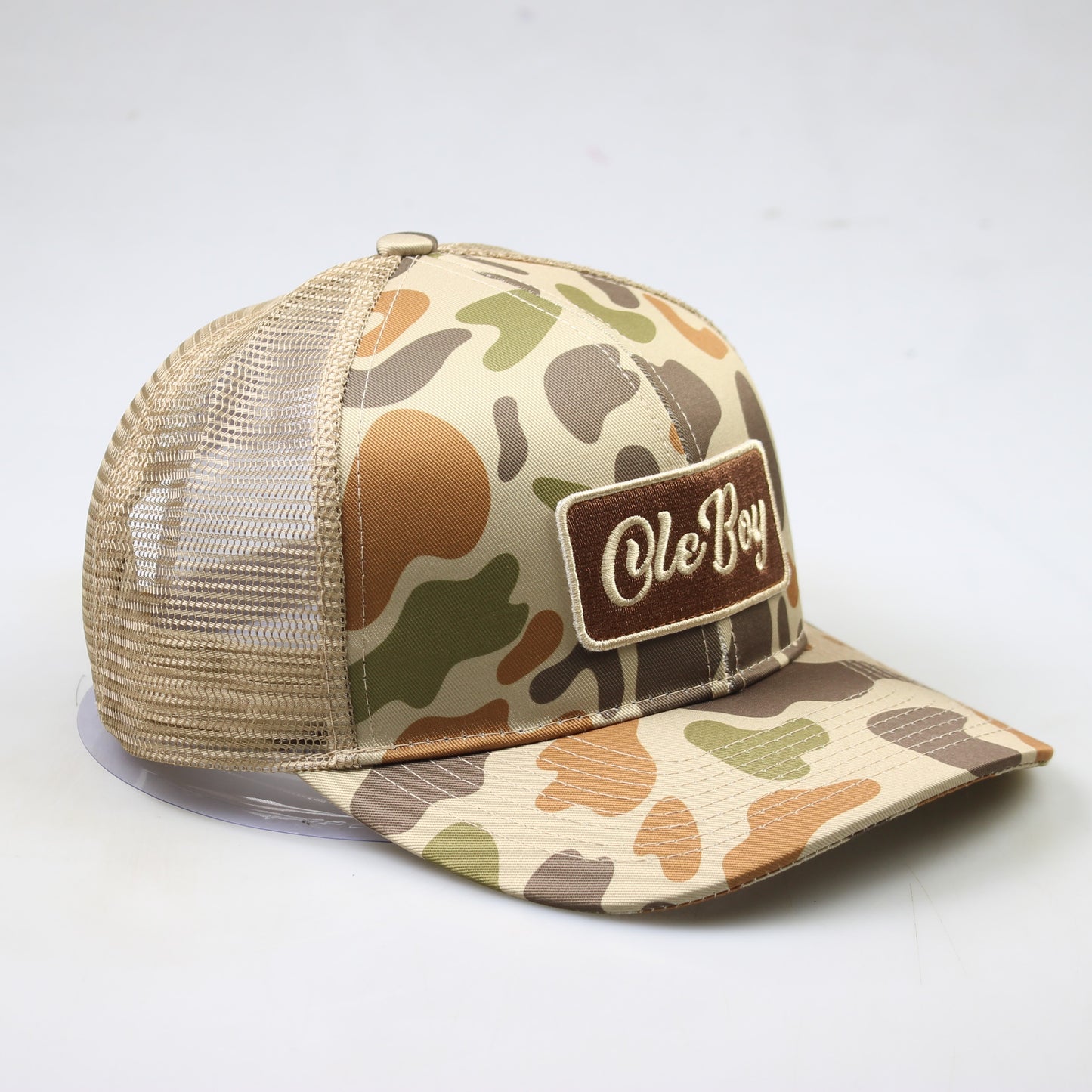 Camouflage trucker hat with 'Ole Boy' patch on a white background