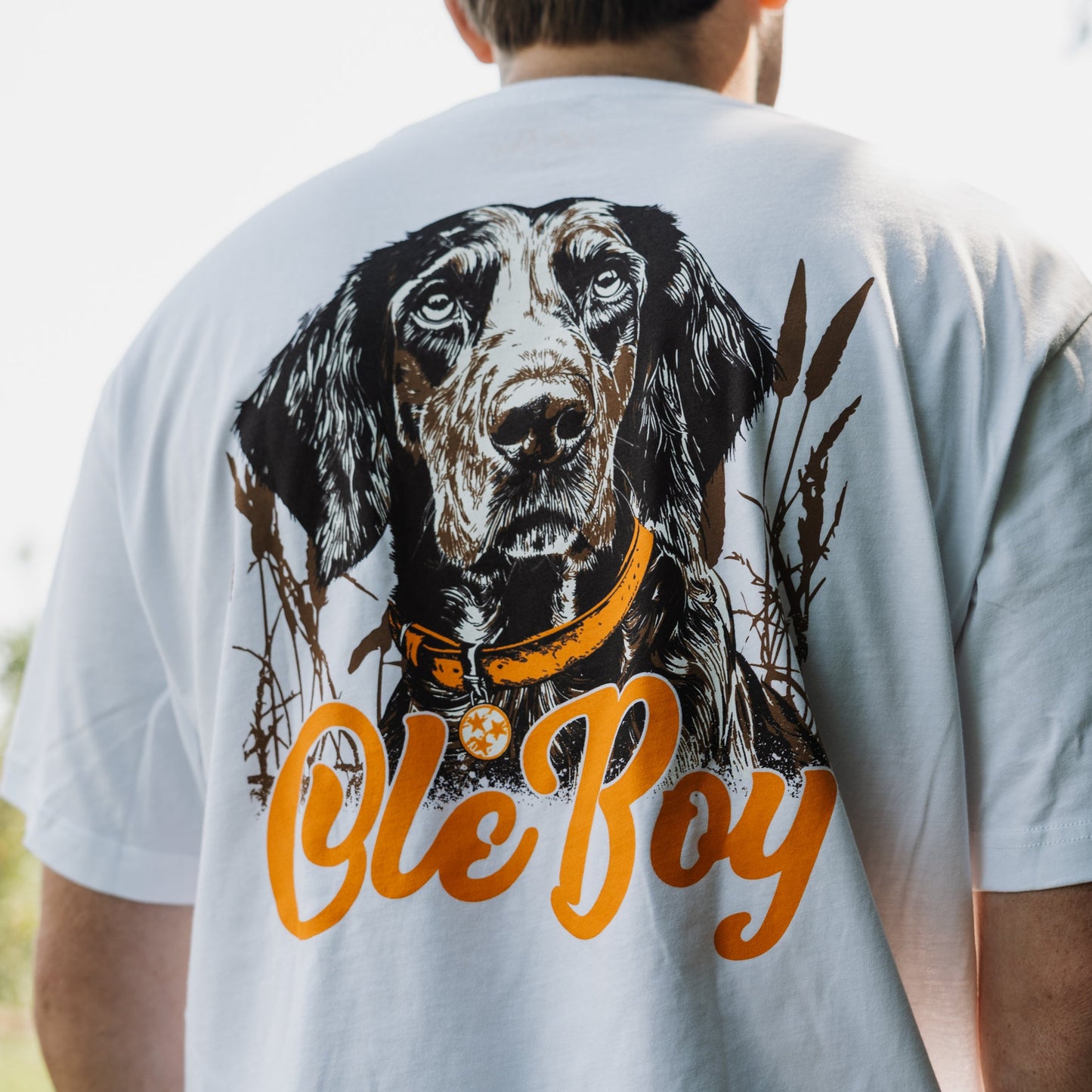 Person wearing a t-shirt with a bluetick coonhound dog illustration and 'Ole Boy' text on the back.