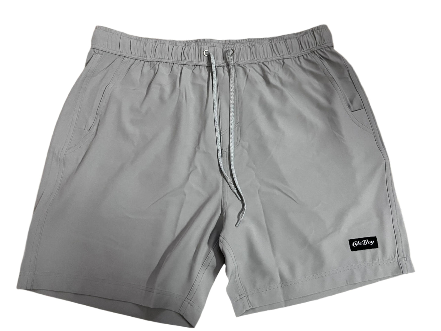 Gray shorts with a ole boy brand label on a white background