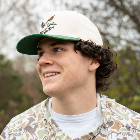 Person wearing a cap with a logo outdoors