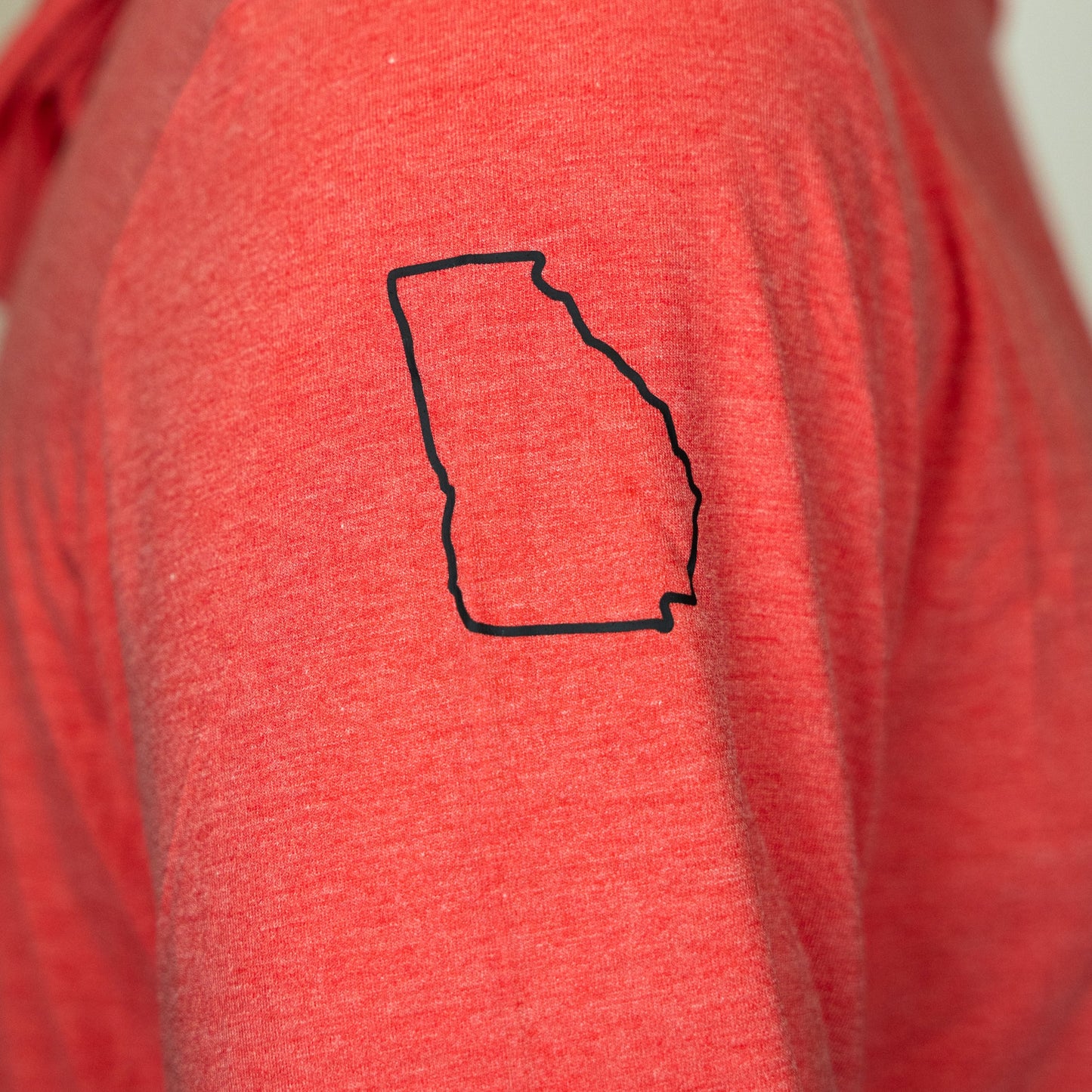 Red shirt with a black outline of the state of Georgia on the chest.