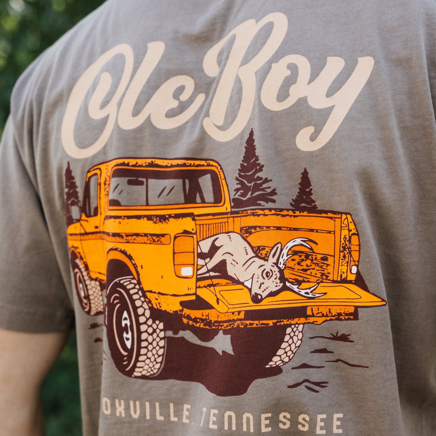 T-shirt with a graphic of an orange truck and 'Ole Boy' text on a brown background