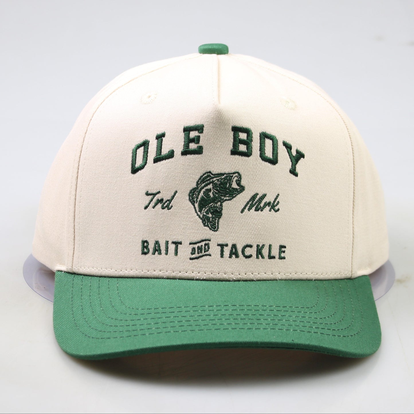 Beige and green cap with 'Ole Boy' branding on a light gray background