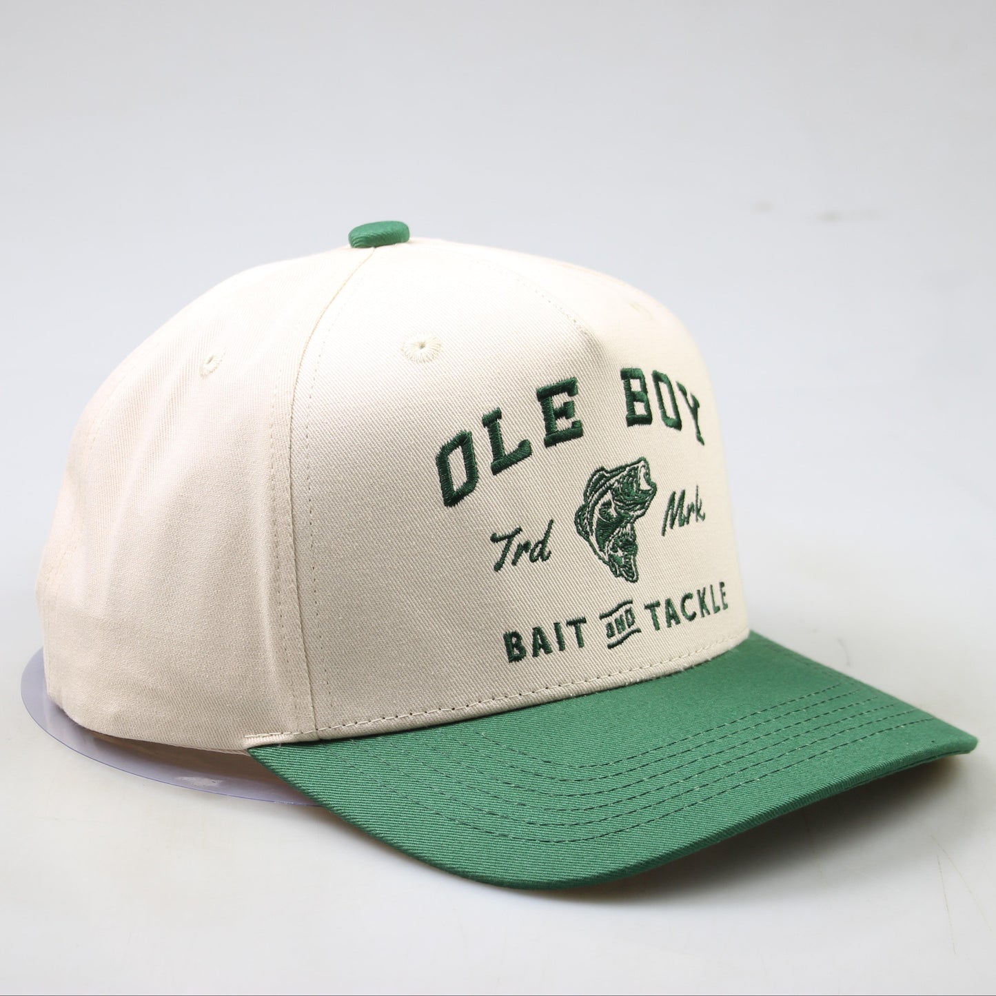 Beige and green cap with 'OLE BOY' branding on a light gray background