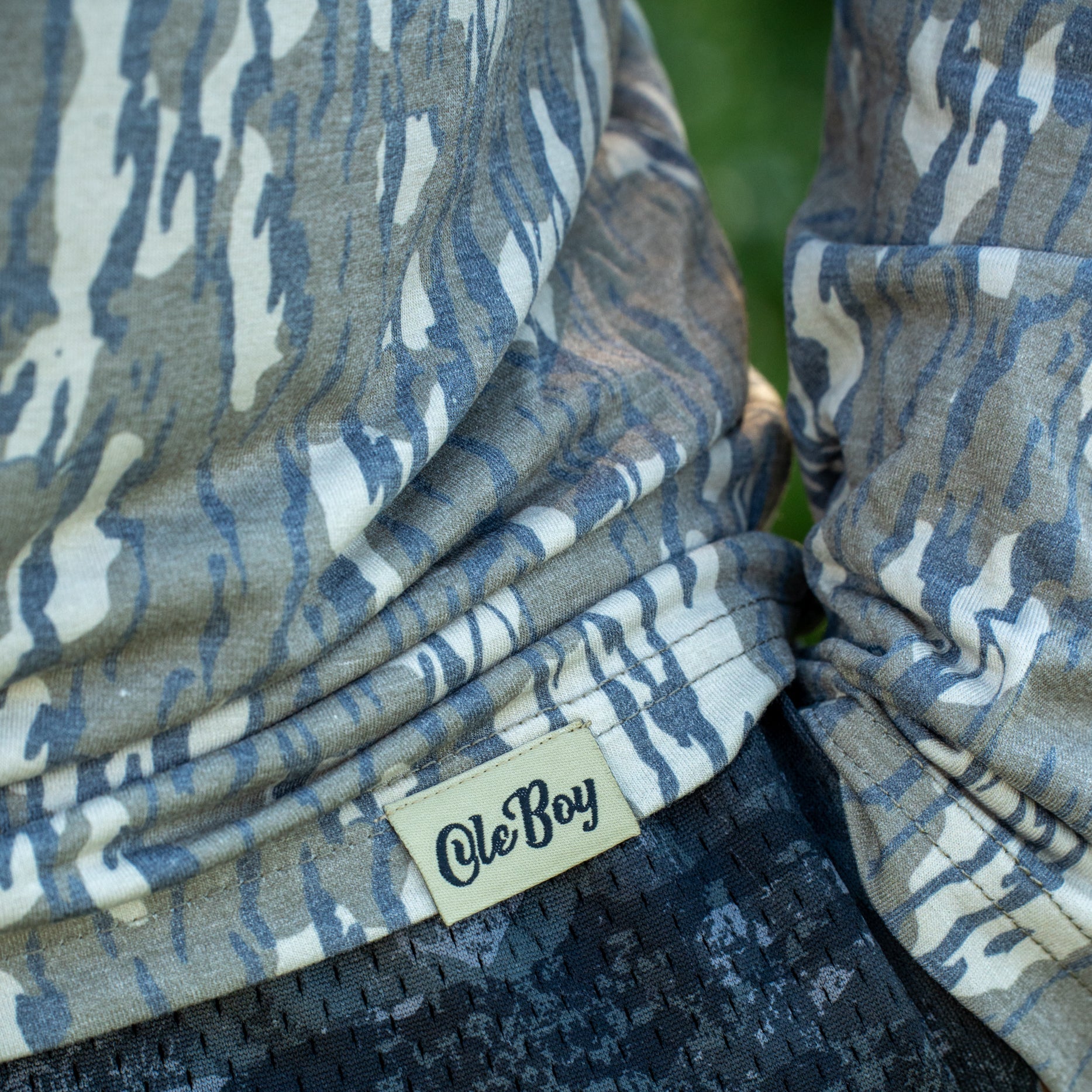 Camouflage-patterned fabric with 'Ole Boy' brand label
