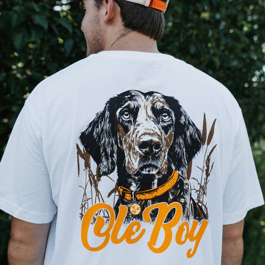 Person wearing a white t-shirt with a coonhound dog graphic and 'Ole Boy' text.