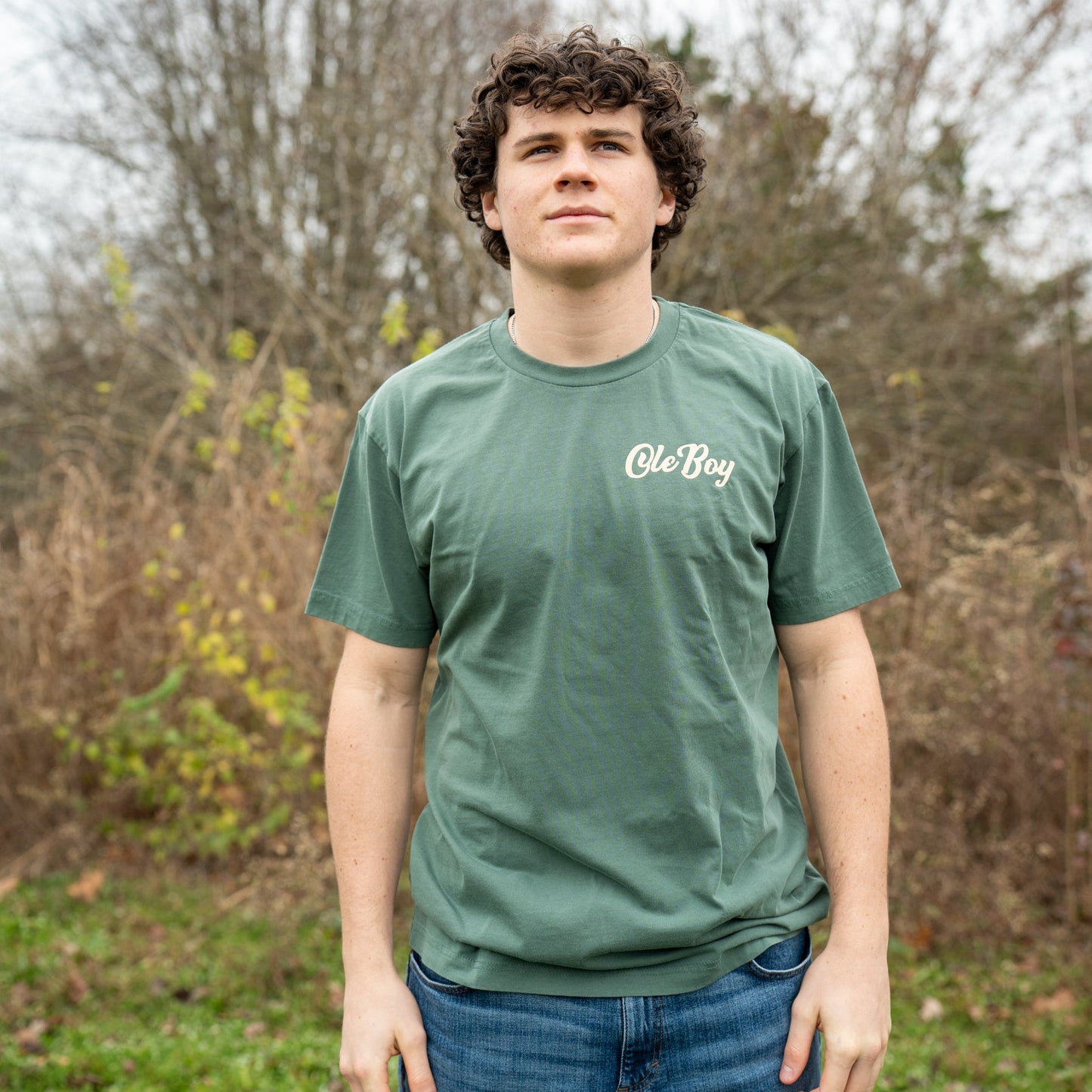 Person wearing a green t-shirt with 'Ole Boy' logo outdoors