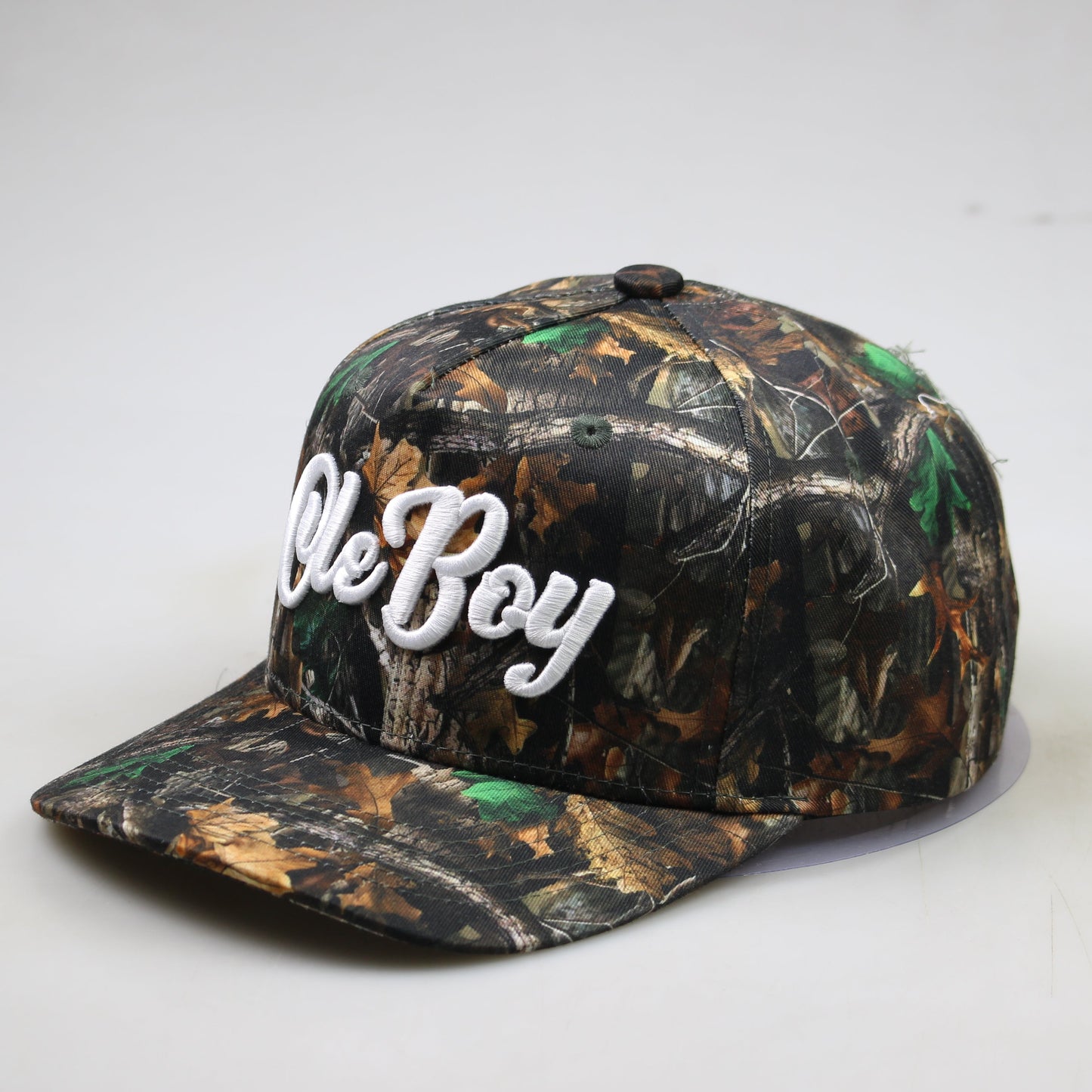 Camouflage baseball cap with 'Ole Boy' text on a white background