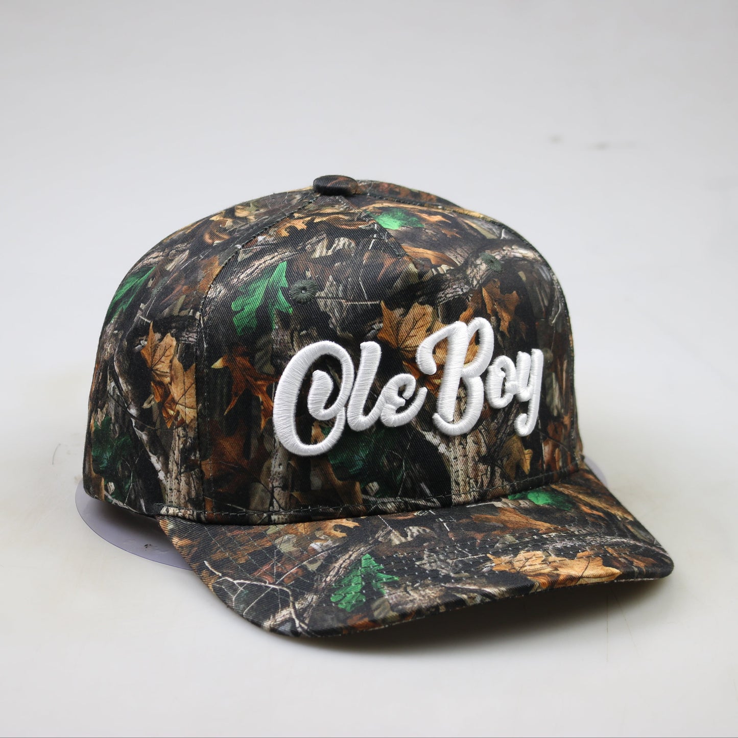 Camouflage-patterned cap with 'Ole Boy' text on a white background