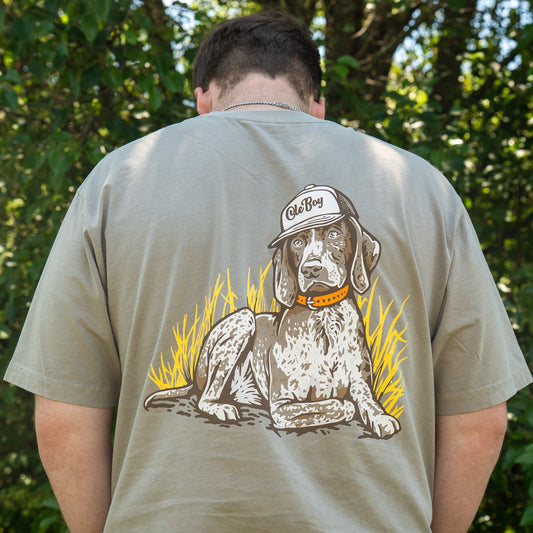 Person wearing a t-shirt with a dog graphic on the back, standing outdoors.