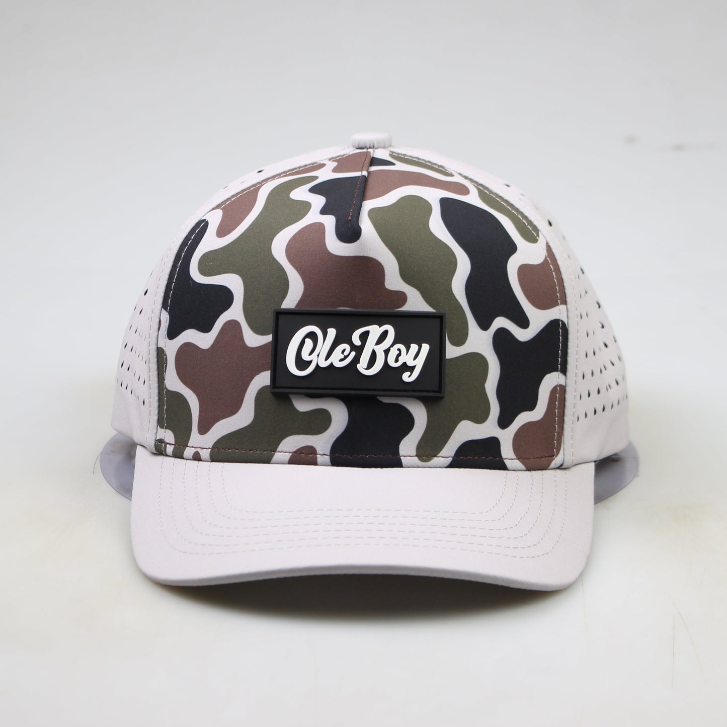 Camouflage-patterned cap with 'Ole Boy' logo on a white background