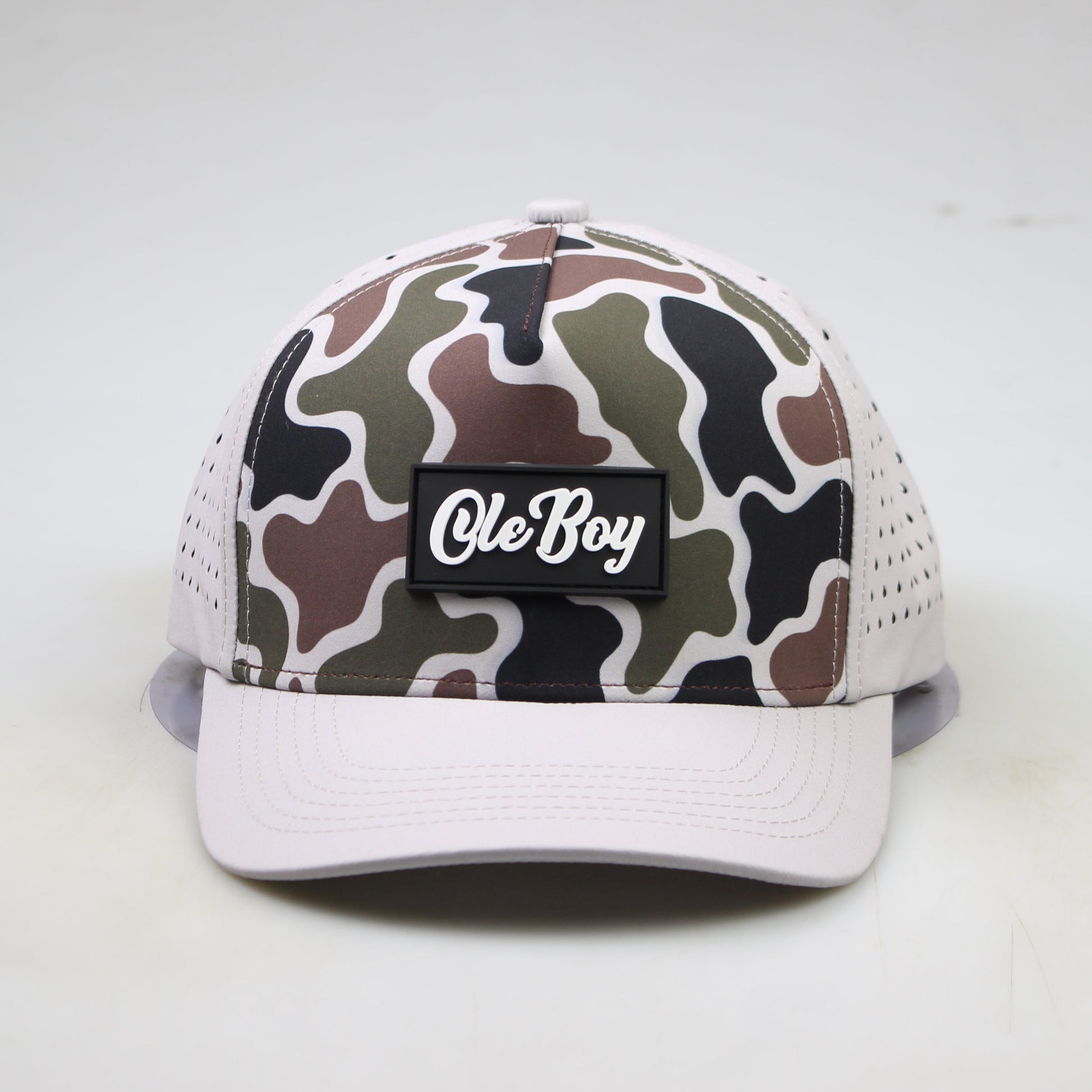 Camouflage-patterned cap with 'Ole Boy' logo on a white background