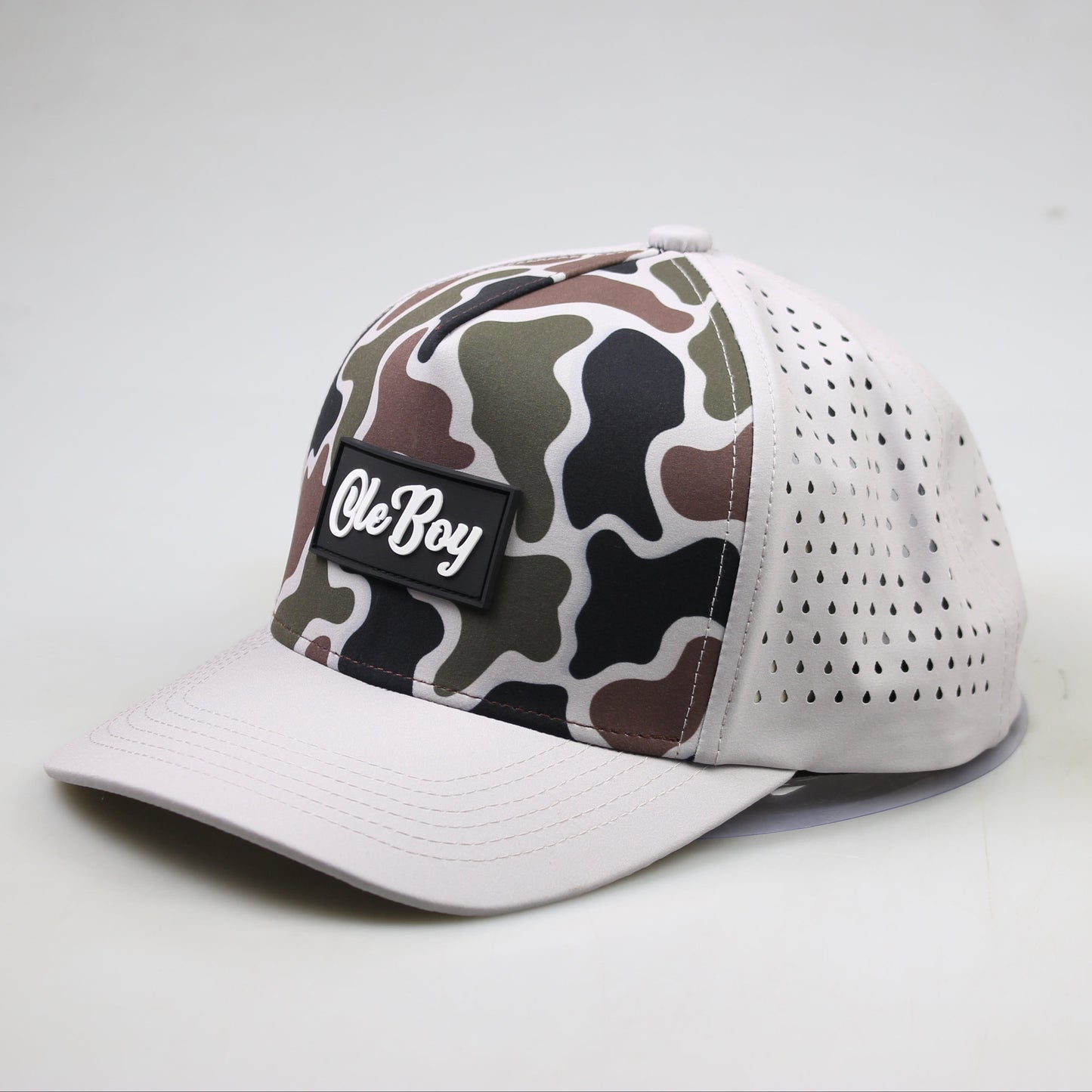 Camouflage-patterned cap with a white brim on a light gray background