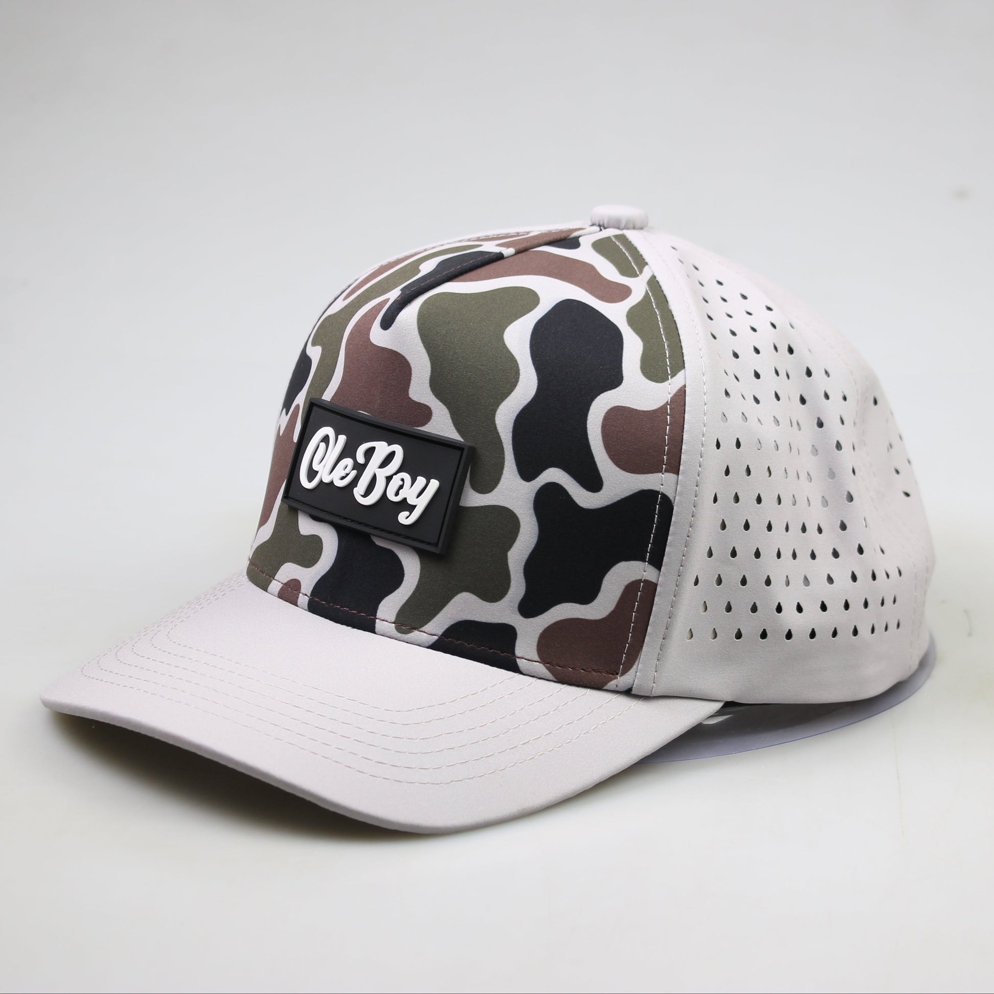 Camouflage-patterned cap with a white brim on a light gray background