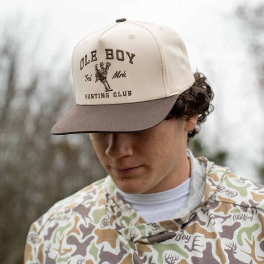 Person wearing a cap with 'Ole Boy' branding outdoors