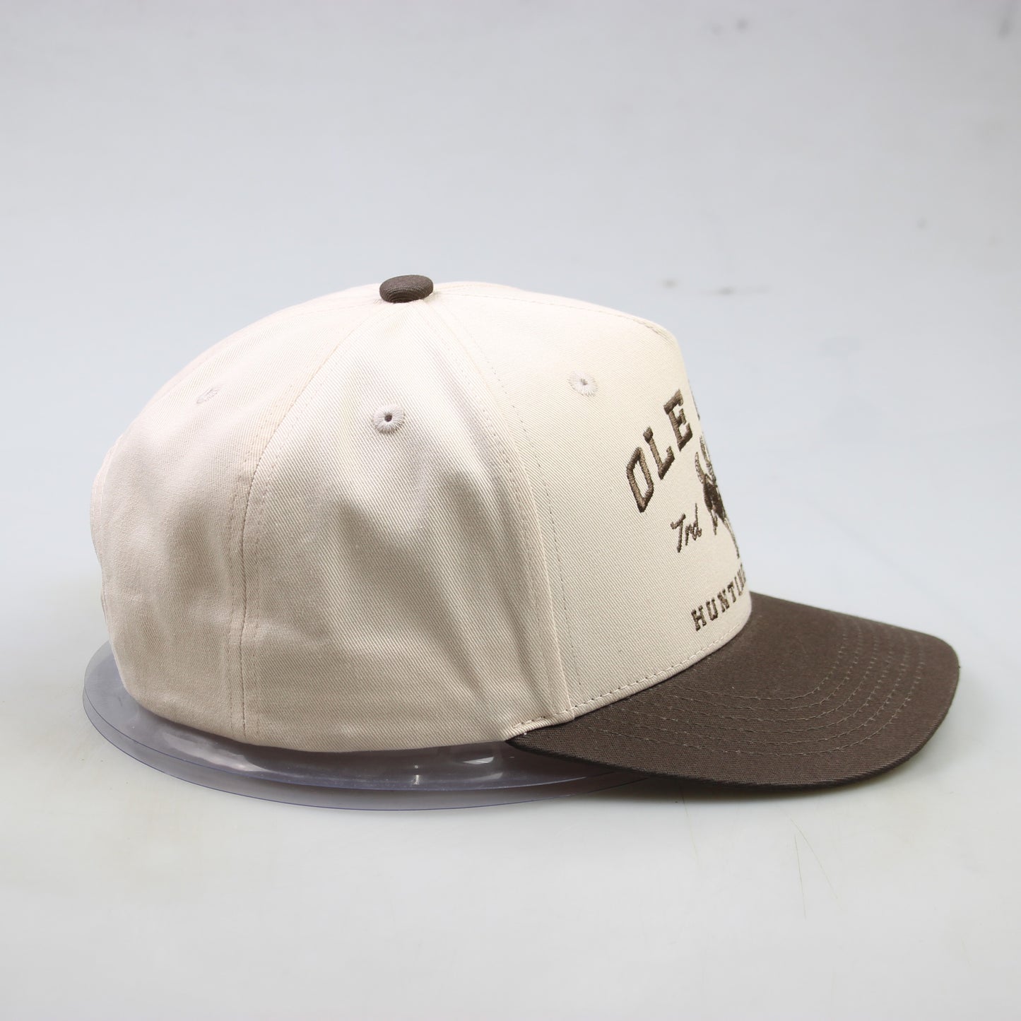 Beige and brown cap with text on a light gray background