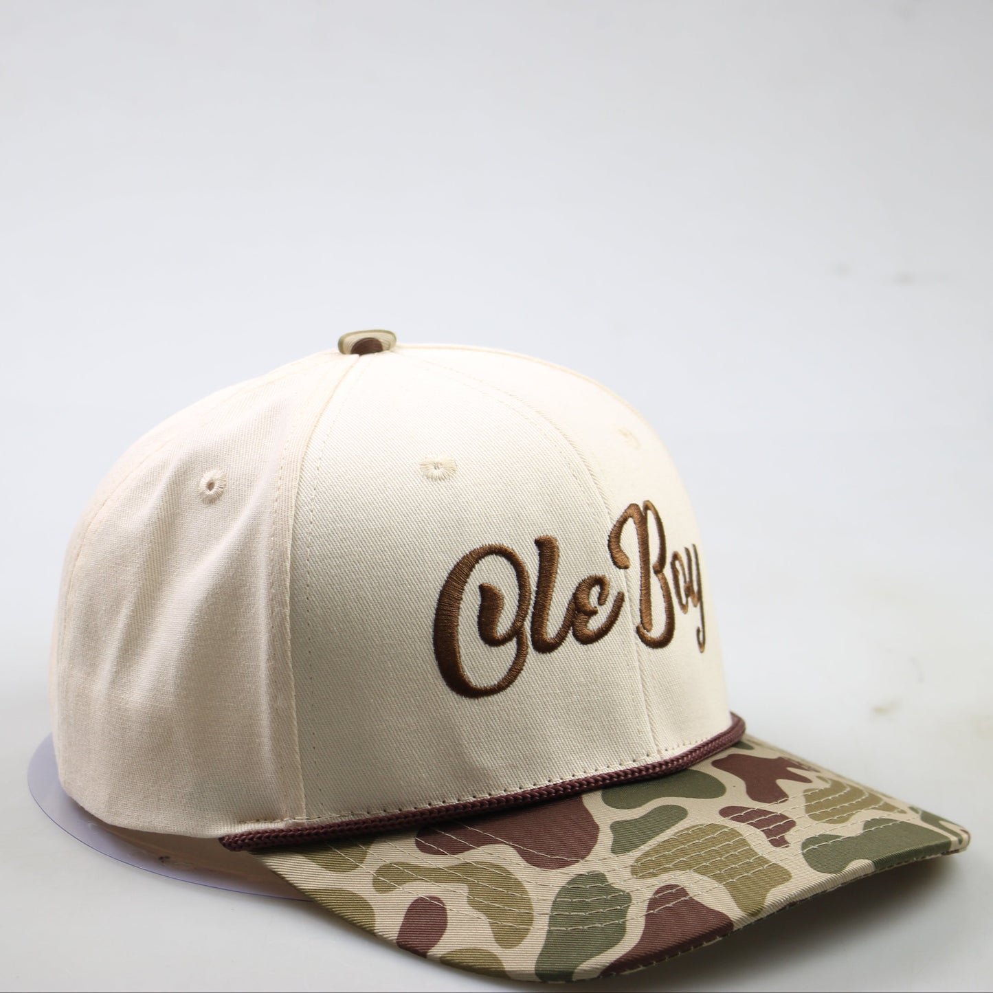 Beige cap with camouflage brim and 'Ole Boy' text on a white background