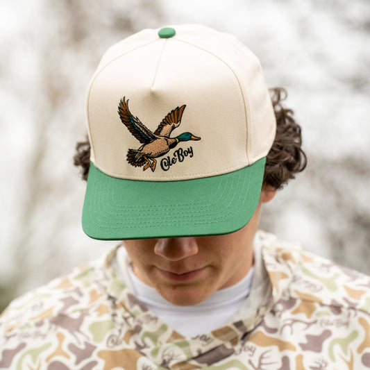 Person wearing a cap with a duck logo and 'Ole Boy' branding, standing outdoors.