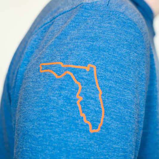 Blue shirt with orange outline of Florida on a white background