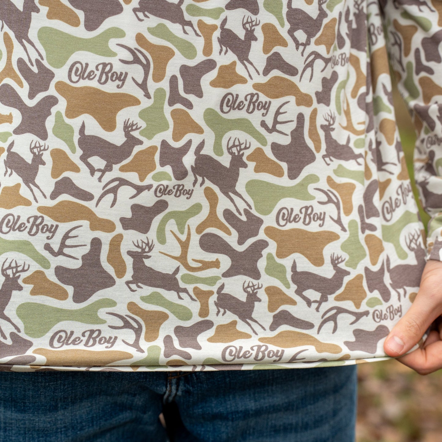 Person holding a box with a camouflage pattern and 'Ole Boy' branding.
