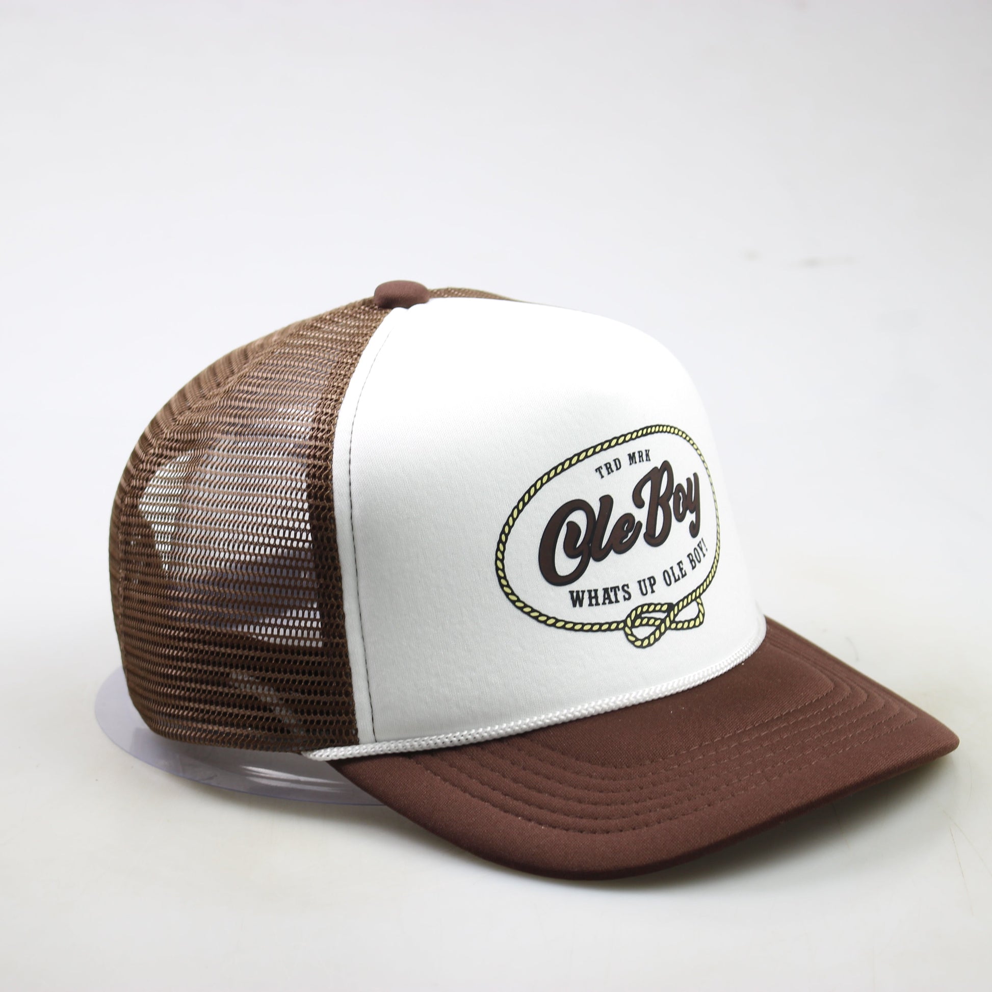 Brown and white trucker hat with logo on a light gray background