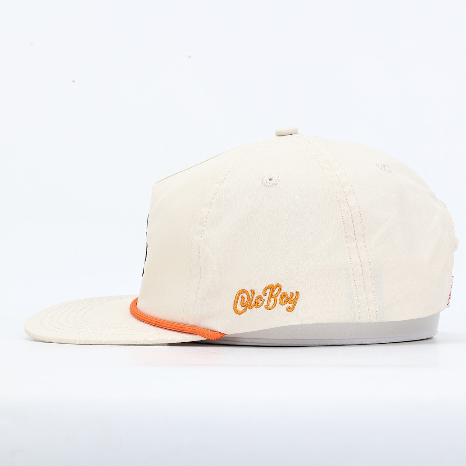Beige cap with 'Ole Boy' embroidery on a white background