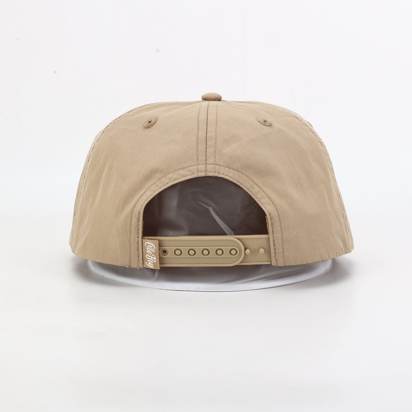 Beige cap with a clear visor on a white background