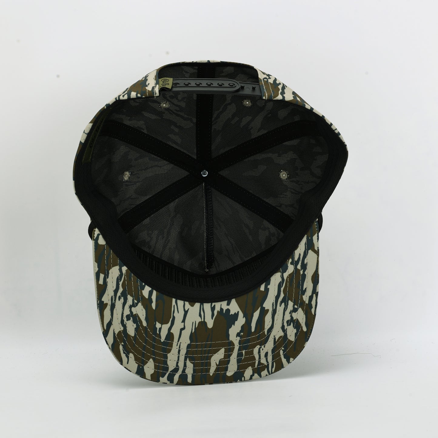 Camouflage-patterned cap with black interior on a white background