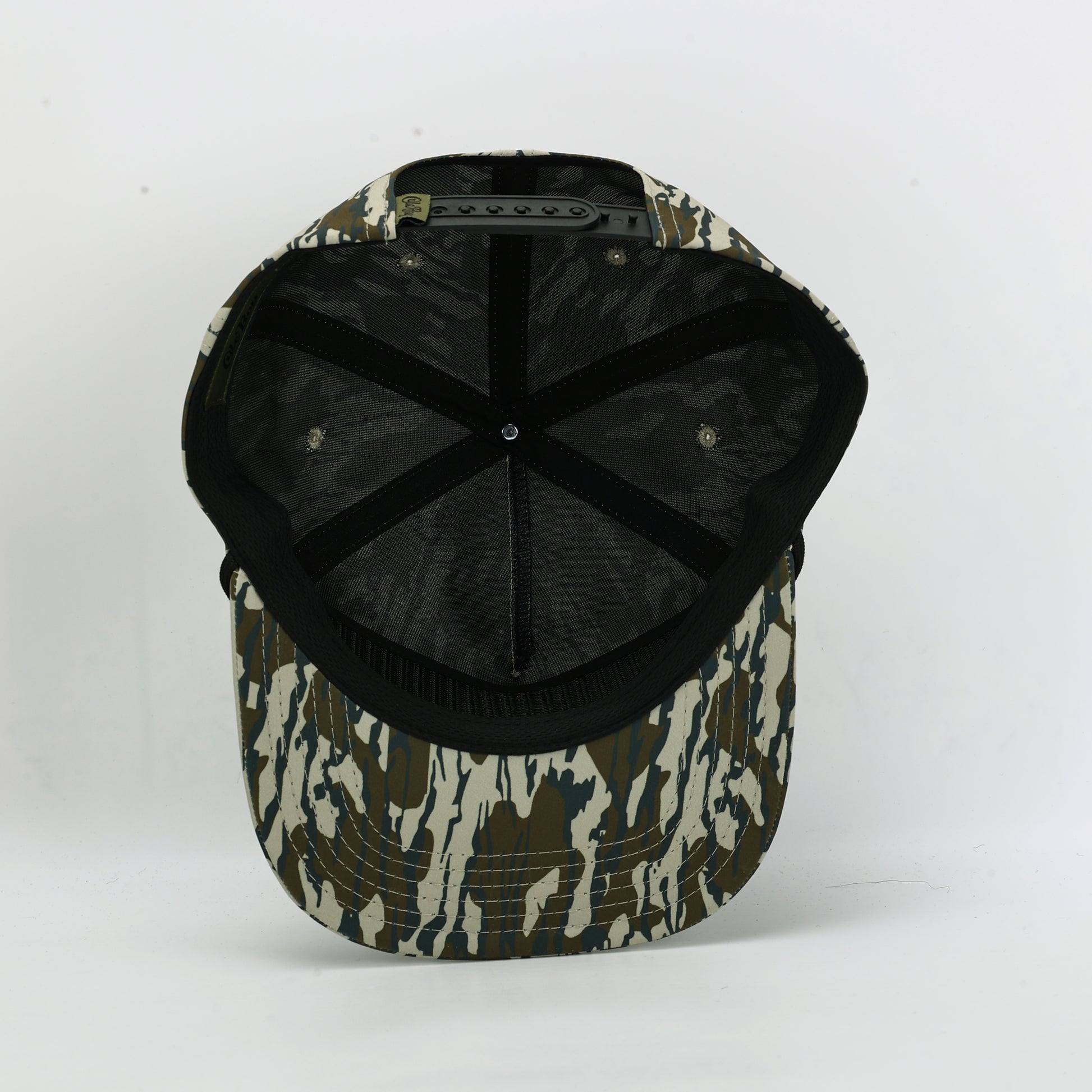 Camouflage-patterned cap with black interior on a white background