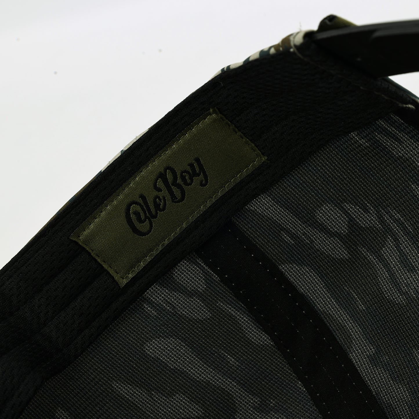 Black cap with a camouflage pattern and 'Ole Boy' logo on a white background