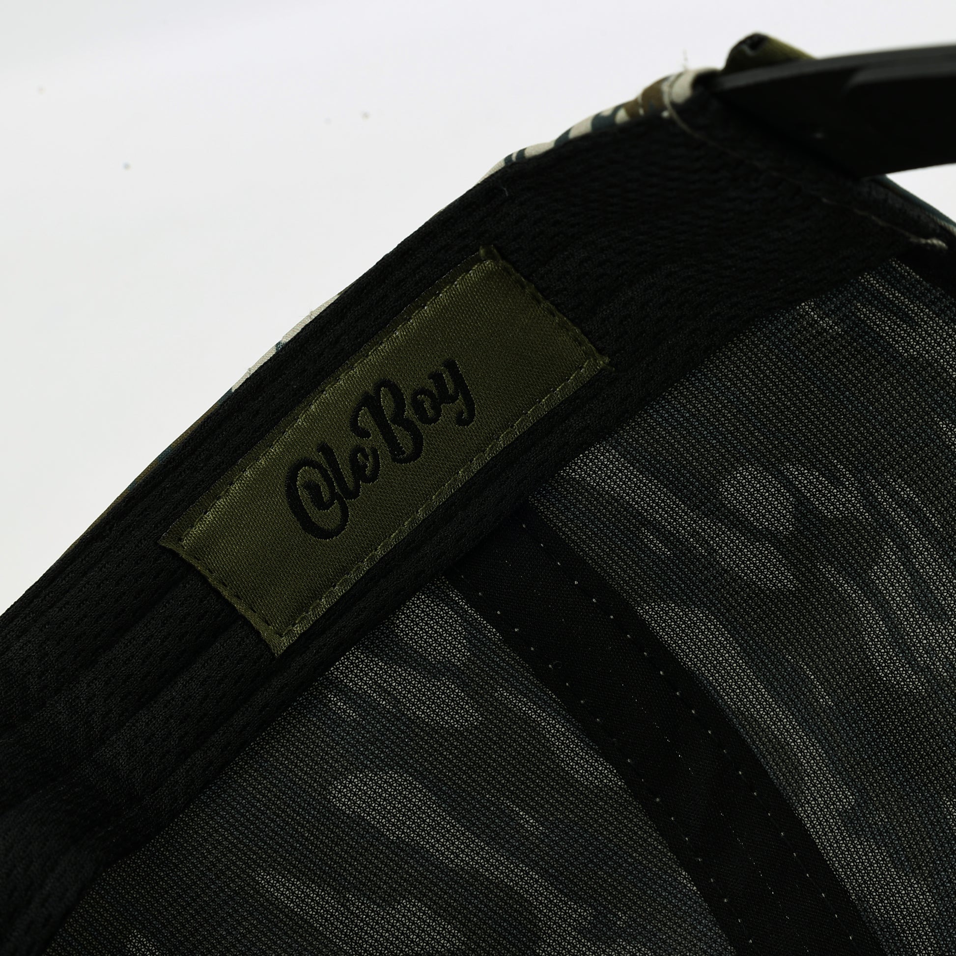 Black cap with a camouflage pattern and 'Ole Boy' logo on a white background