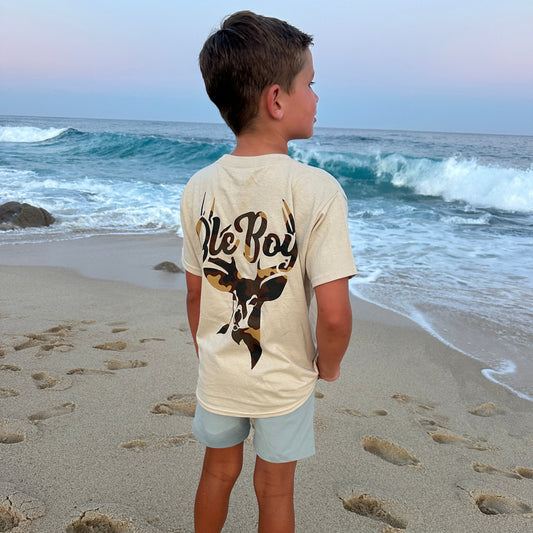 Person wearing a 'Ole Boy' t-shirt on a beach