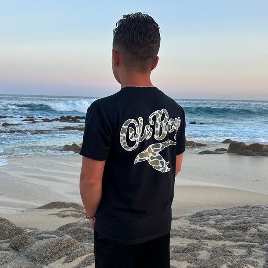 Person standing on a beach with ocean waves in the background