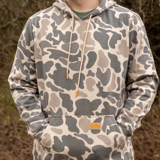 Camouflage hoodie worn by a person in an outdoor setting