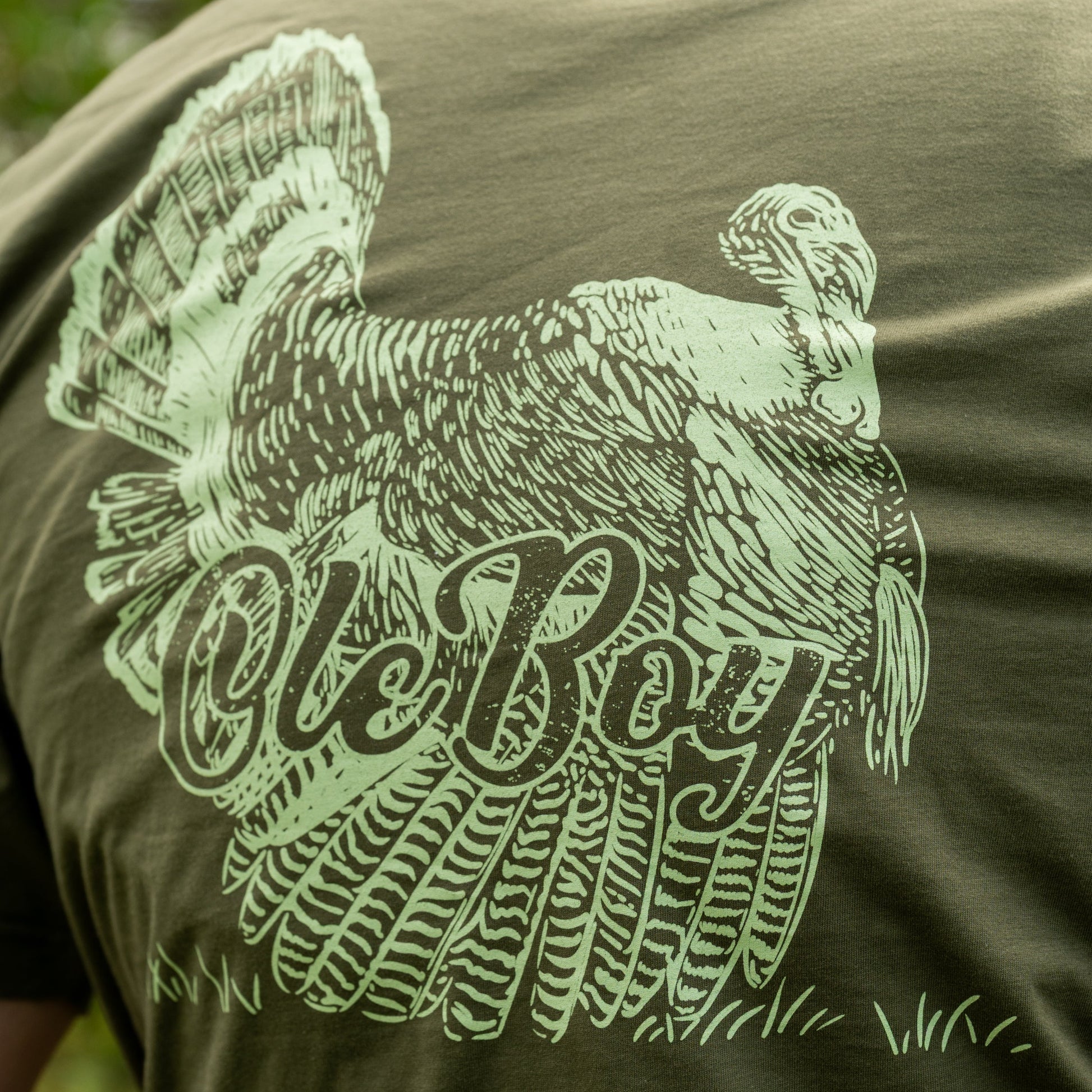 Green t-shirt with a graphic of a Turkey and 'Ole Boy' text on an olive green background.